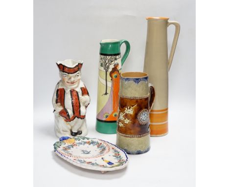 A Bisto jug, two other jugs, a Toby jug and a Quimper saucer, tallest 39cm