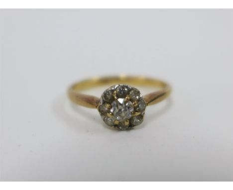 18ct gold diamond daisy cluster ring, claw set with nine diamonds, stamped 18ct, UK ring size P 