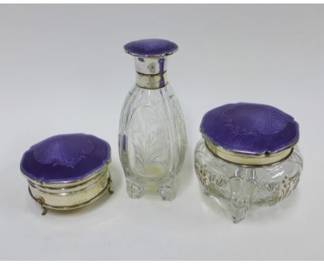 George V silver and enamel mounted glass dressing table set comprising a bottle, powder jar and silver trinket box, all with 