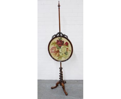 19th century rosewood polescreen, on a barley twist pedestal base, with a floral embroidered panel. 47 x 180cm 