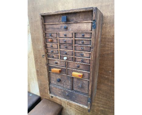 A VINTAGE VICTORIAN PINE WATCHMAKERS HABERDASHERY CABINET, ENCLOSING 24 VARIOUS SIZED DRAWERS AND TO INCLUDE A CONTENTS OF TO