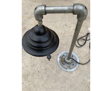 AN INDUSTRIAL STYLE TABLE LAMP WITH CAGE SHADE AND BEARING THE LABEL 'THE NOBLE LIGHTING COMPANY' 
