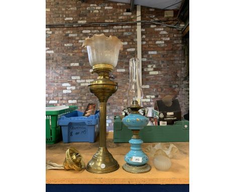 A LARGE BRASS OIL LAMP WITH COLUMN STAND AND FLUTED GLASS SHADE AND ANOTHER WITH TURQUOISE AND FLOWER PATTERNED BASE PLUS AN 