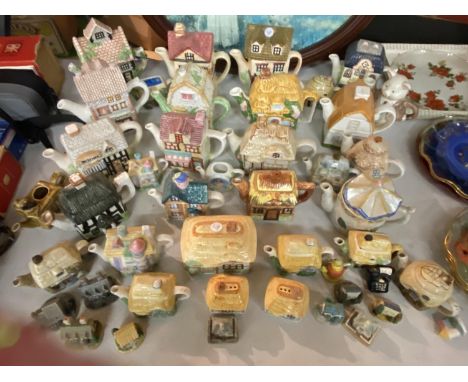 A LARGE QUANTITY OF CERAMIC COTTAGE ITTEMS TO INCLUDE TEAPOTS, ORNAMENTS, ETC 