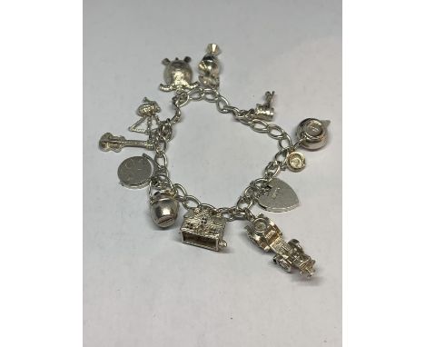 A MARKED SILVER CHARM BRACELET WITH TEN CHARMS TO INCLUDE BAG PIPES, TURTLE, BOOT, HOUSE, GUITAR ETC IN A PRESENTATION BOX 