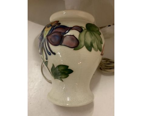 A POSSIBLY MOORCROFT TABLE LAMP WITH MAUVE PLEATED SHADE (MARKED TO BASE) 