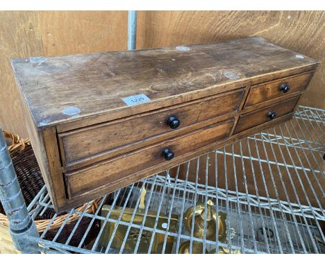 A VINTAGE WOODEN CHEST ENCLOSING FOUR DRAWERS 