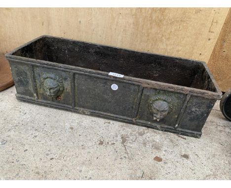 A VINTAGE HEAVY CAST IRON WINDOW BOX PLANTER WITH LION HEAD DECORATION 