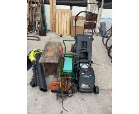 AN ASSORTMENT OF GARDEN TOOLS TO INCLUDE A BLACK AND DECKER LAWN MOWER, GARDEN SHEARS AND CROWBAR ETC 