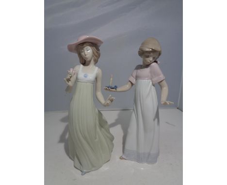 TWO NAO FIGURINES OF LADIES, ONE WITH A CANDLE AND THE OTHER HOLDING A FLOWER 