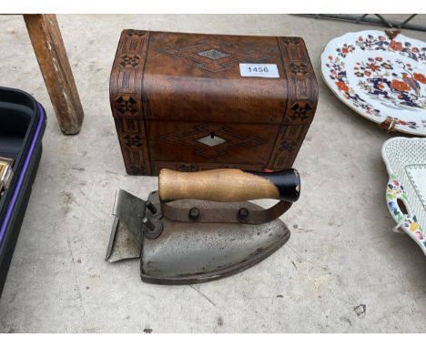 A VINTAGE IRON AND AN INLAID WOODEN TEA CADDY 
