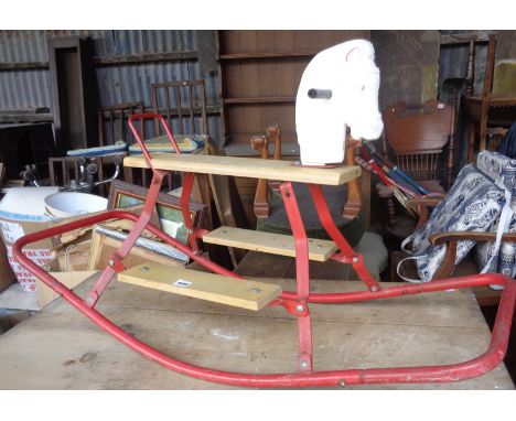 Vintage child's rocking horse on metal frame