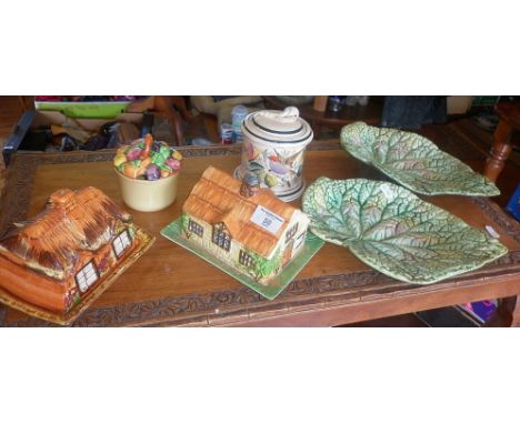 Beswick ware cottage butter dish, a Prices similar, a Continental tobacco jar with pipe handle, two majolica leaf plates (A/F