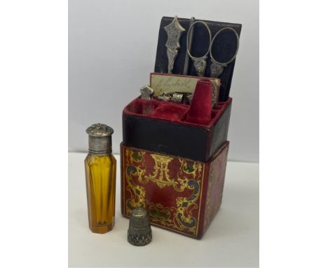  A 19th century etui/necessaire in a tooled red leather case inscribed "Lady's Companion" with scrolling gilded decoration in