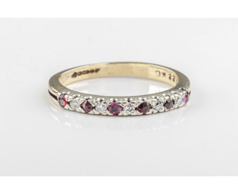  A ruby and diamond half eternity ring in 9ct yellow gold with alternating claw-set rubies and diamonds, ring size J. 