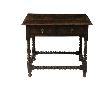  A late seventeenth century pegged oak side table the three plank top over two frieze drawers with split pin pear drop handle