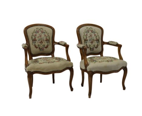  A pair of Louis XV style walnut fauteuils, circa 1880 with tapestry upholstery and studwork surround, 83.8cm. high. (2) 