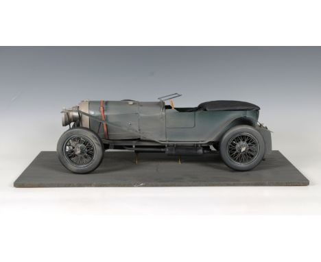 A metal model of a Bentley grey livery, racing number "4" to trunk and radiator, on a painted wooden base 60 x 30cm. x 16cm.