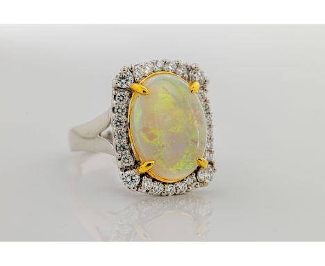  An opal and diamond ring in 18ct white and yellow gold, the beautiful cabochon white opal weighing 3.96cts, within a brillia