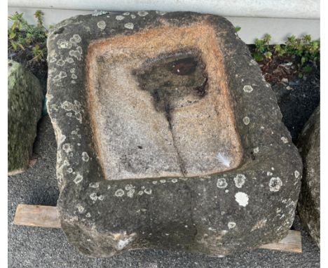  A large weathered deep rectangular granite trough with shallow well approximately 54cm high by 74cm in length and 60cm wide.