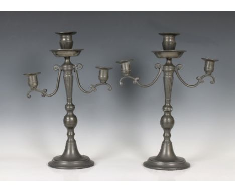  A pair of 19th century pewter twin branch candelabra with central sconce 38.1cm. high. 