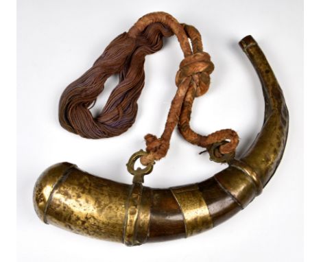  A Persian brass mounted horn powder flask 19th century, the mounts having stylised decoration, shaped carrying strap loops, 