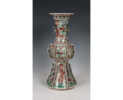  A Chinese wucai porcelain dragon vase early 20th century, trumpet form neck with raised mask design, finned bulbous central 