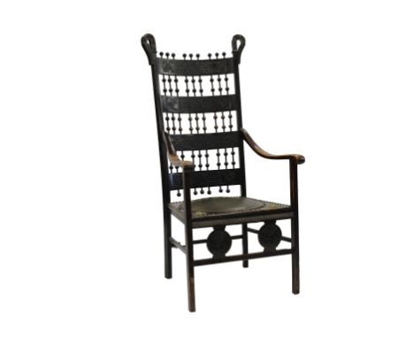  A mahogany and brass Arts and Crafts chair the uprights with curling swan neck finials, flanking turned bobbin finials on ca