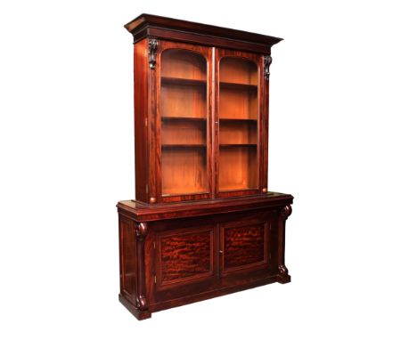  A Victorian mahogany glazed bookcase an unusual marriage, the glazed top section with arched cupboard doors opening to adjus