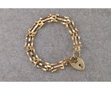  A 9ct yellow gold padlock and gate chain bracelet with safety chain, marked 9ct on padlock and ring. 