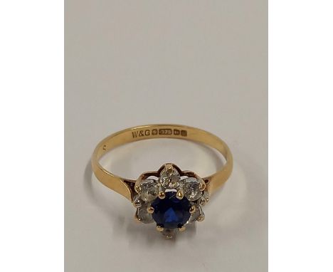 A CIRCULAR CLUSTER RING SET IN 9ct, SIZE 'K'