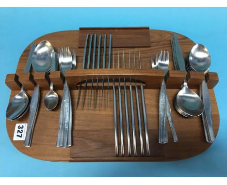 A quantity of stainless steel cutlery on a tea caddy