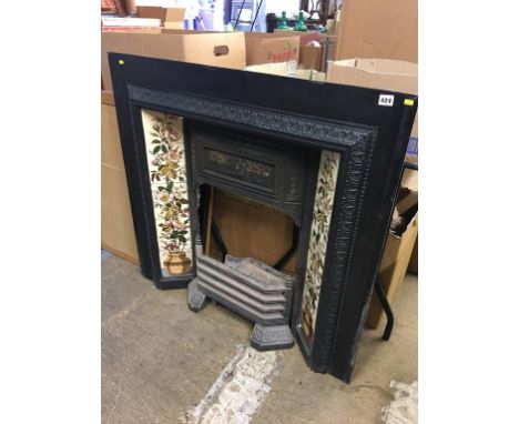 A Victorian cast iron fire surround, with tile inset and grate