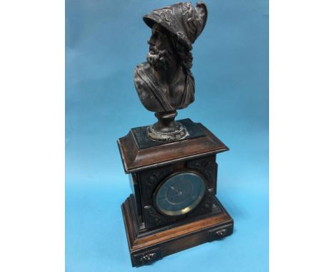 A mantle clock, mounted with a spelter bust of Apollo