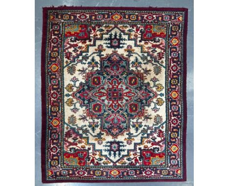 A 20th century Persian Pabla Kashan hand woven wool floor carpet rug. The rug having a central foliate shaped medallion in po