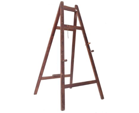 A large early 20th century oak artist's folding easel with adjustable pegs. The easel having four squared splayed supports un