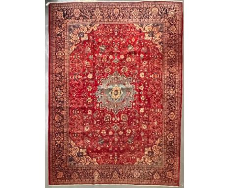 A large 20th century North West Persian Sarouk floor carpet rug. The rug having a central light blue ground medallion of flow