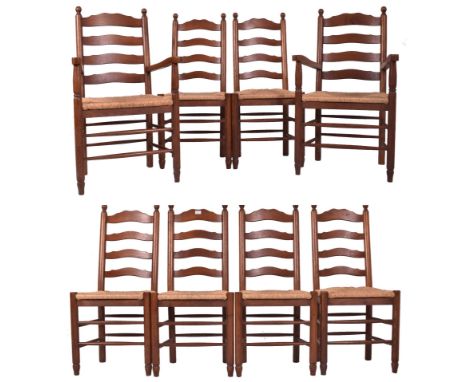A matching set of eight 20th century oak and rush seated North Country ladderback dining chairs. Each chair having an oak lad