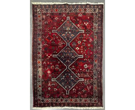 A 19th century Khamseh Confederation floor carpet rug. The rug having three geometric dark ground medallion to centre within 