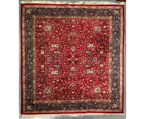 A squared early 20th century Persian Islamic Kashan floor carpet rug. The rug having a central red ground panel with intricat