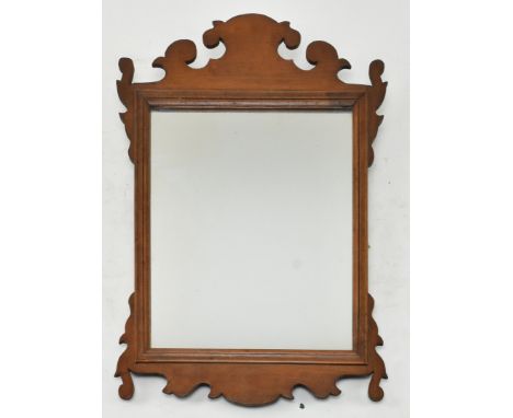 A 19th century mahogany fret-work Chippendale inspired pier wall hanging mirror. The mirror having carved scrolled fretwork t