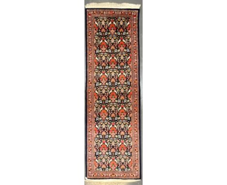 A Persian Kashan pictorial wool floor carpet runner rug. The runner rug having a central cobalt blue panel intricately decora