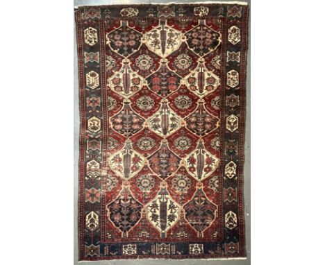 An early 20th century Persian Islamic Bakhtiari hand woven floor carpet rug. The rug having a central panel with series of fl