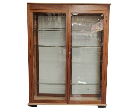 A large 20th century mahogany haberdashery shop display cabinet. The cabinet having a pediment atop with fitted frieze below.