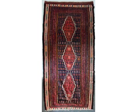 A contemporary Persian Islamic Kilim floor carpet runner rug. The rug having a central panel with three lozenge shapes in red