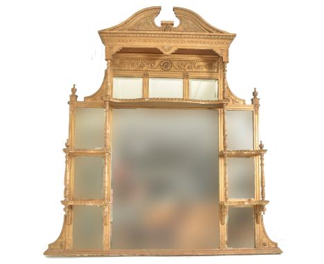 An early 20th century gilt wood over mantel mirror shelf. The mantel mirror having a hood pediment atop with floral embellish