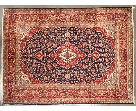 A 20th century Central Persian Islamic Kashan floor carpet rug. The carpet having a central red &amp; white ground medallion 