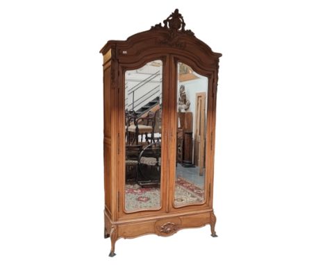 A French 19th century Louis XV style kingwood mirror front armoire wardrobe. The wardrobe having a carved foliate embellishme