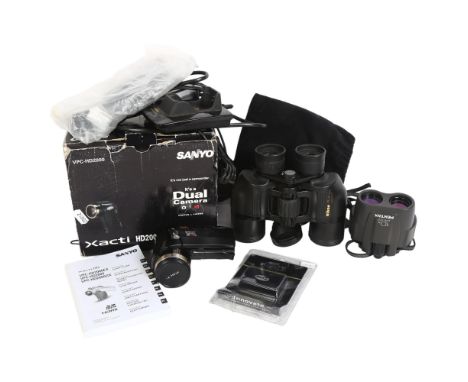 A pair of Nikon Action 8x40, 8.2 degree binoculars, a Sanyo Xacti HD2000 dual camera and camcorder, in original box with asso