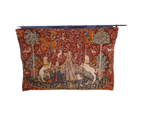 A machine woven tapestry, on associated hanging rail, depicting a Medieval lady in woodland surrounded by mythical creatures,